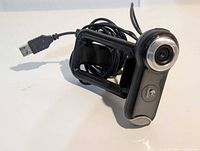 Webcam coiled with USB-A plug visible