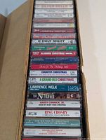 Vertical view of full stack of holiday cassette tapes in cardboard box