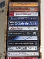 Stack of 12 cassette spines showing titles Pachelbel to Origins