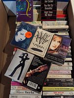 Open box showing multiple cassette tapes including Charles & Eddie, Joe Cocker and others