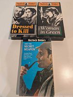 Three Sherlock Holmes Mystery Classics VHS tapes: Dressed to Kill, The Woman in Green, And the Secret Weapon