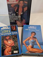 Front view of all three VHS tapes with slipcovers visible