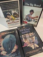 Front view of all four VHS tapes with cover art visible