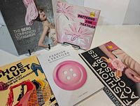 All five fashion and textile books laid out showing full covers