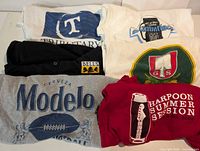 All six shirts laid out showing front graphics