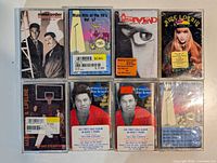 All eight sealed cassette tapes laid out in two rows