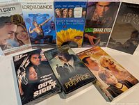 All eight sealed VHS tapes laid out showing front covers