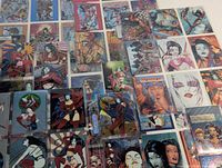 Wide view of mixed holographic and standard finish trading cards in protective holders