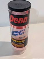Full view of sealed tube showing Penn branding and pink balls