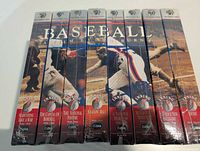 Front spines of eight sealed VHS cases showing inning numbers and subtitles