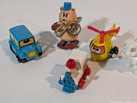 Group view of five Tomy wind-up toys