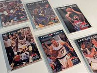 Assorted USA Basketball cards sleeved featuring Ewing, Johnson, Malone, Barkley, Mullin, Bird