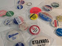 Group view of mixed campaign buttons in bags