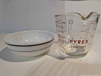 Pyrex measuring cup and Corning bowl side by side