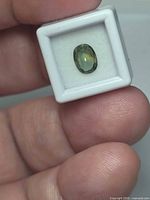 Oval blue green sapphire in display box