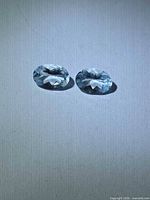 Pair of oval aquamarine gemstones front view
