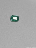 Front view loose emerald on grey background