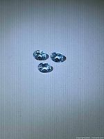 Three oval sky-blue topaz stones face-up