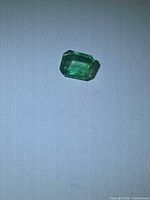 Front view of loose octagon cut emerald gemstone