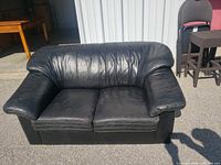 Front view of black leather loveseat