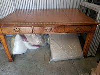 Full view of table showing drawers and leather top