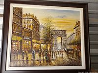 Full view of framed oil painting depicting Arc de Triomphe and street scene