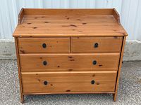 Front view showing four drawers and hardware