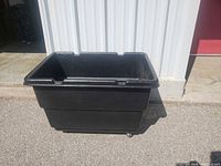 Overall view of black wheeled bin outdoors