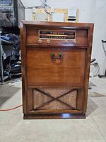 Full front view of Philco console showing cabinet, dial, door and speaker grille