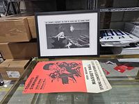 Framed print and loose poster displayed together on table
