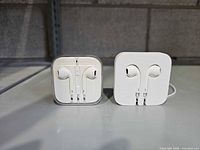 Both sets of Apple EarPods side by side showing packaging styles