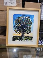 Framed painting in light wood frame with mat showing full artwork