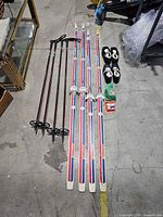 Full lot laid out showing skis, poles, boots, accessories