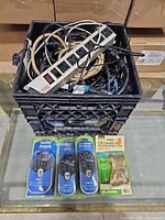 Overall lot with crate of cables, power strip on top, packaged cables and speaker wire in front