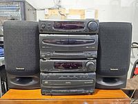Front view of full system: four stacked Technics CH90 components flanked by matching speakers