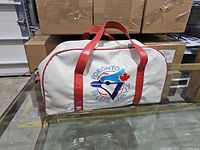 Front view showing Toronto Blue Jays logo, red handles, white vinyl body