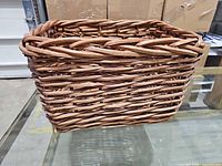 Front and side view of woven wicker rattan rectangular basket on glass table