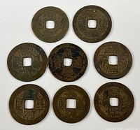 Obverse of eight Chinese cash coins showing Chinese characters and wear