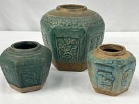 Three ginger jars side by side displaying size variation and glaze