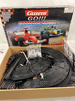 Box with Carrera GO!!! Formula Speed artwork and contents visible including bagged cars