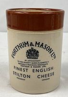 Front view of Fortnum & Mason stoneware crock showing printed text and brown rim