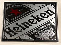 Front view of entire Heineken mirror showing design and frame