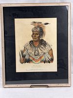 Full view of framed lithograph with black mat and light frame