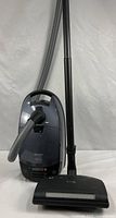 Full view of canister vacuum with hose, wand and powerhead