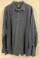Front view of shirt showing pleated placket, plaid pattern, collar and chest pocket