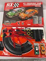 Box lid showing artwork of green Audi and orange Mercedes cars