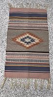 Full view of the rectangular flat-woven rug with fringe