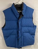 Full front view of royal blue North Face puffer vest on hanger
