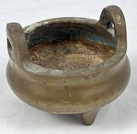 front view of bronze tripod censer showing handles and interior