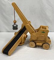 Full view of wooden crane and conveyor belt set